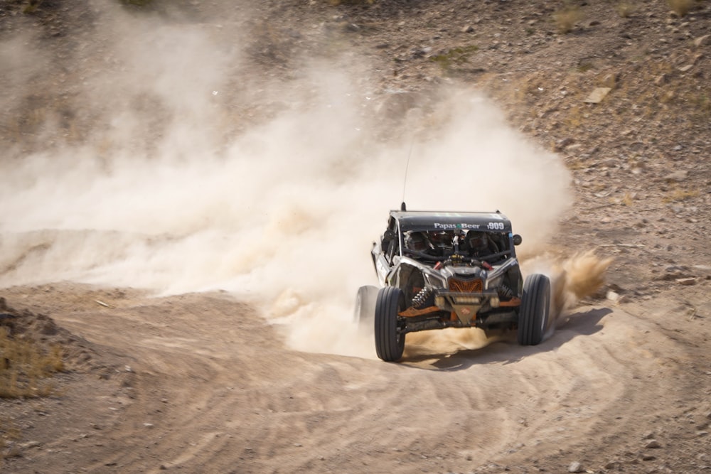 a person driving a buggy on a dirt road