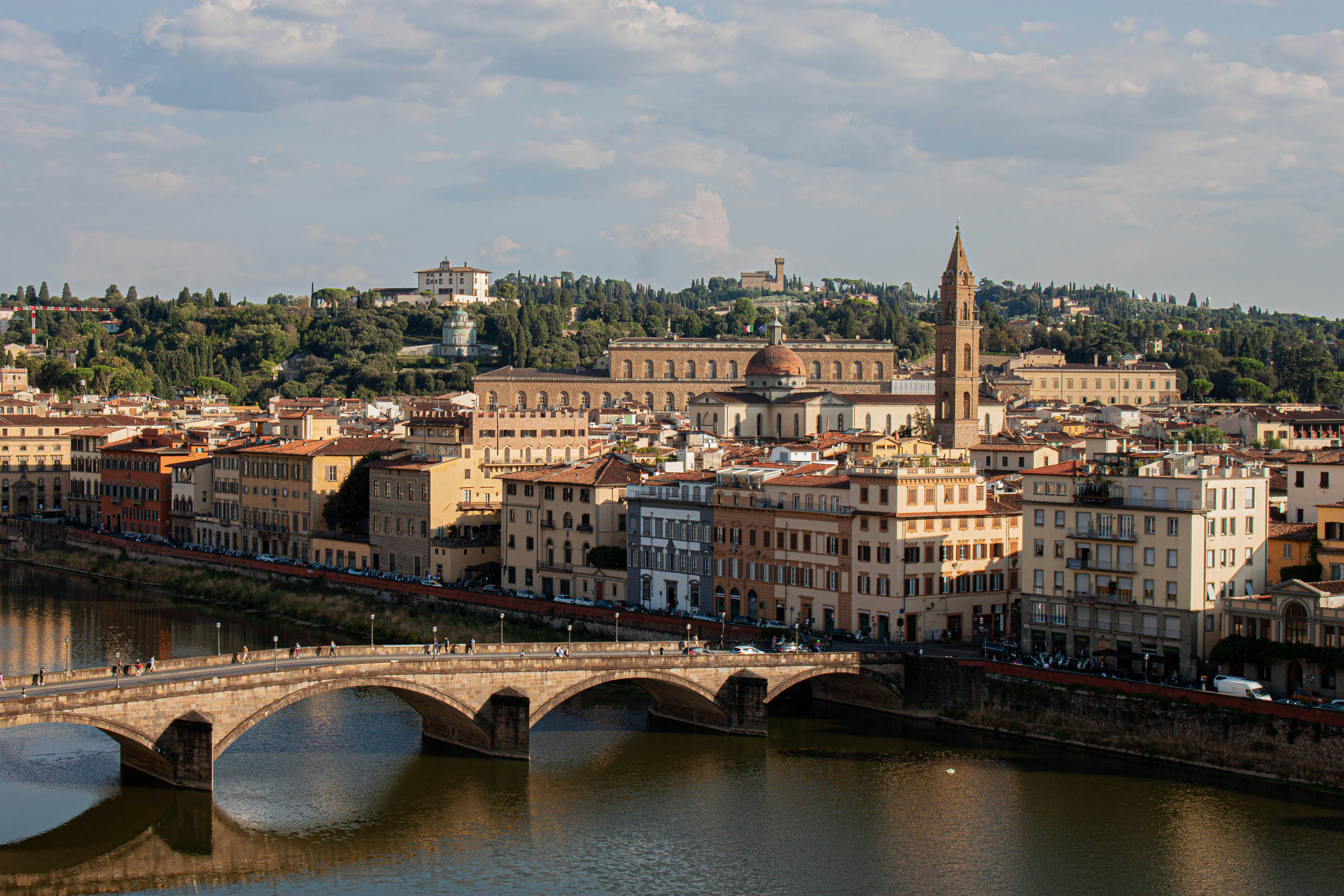 A bridge over a river with a city in the background