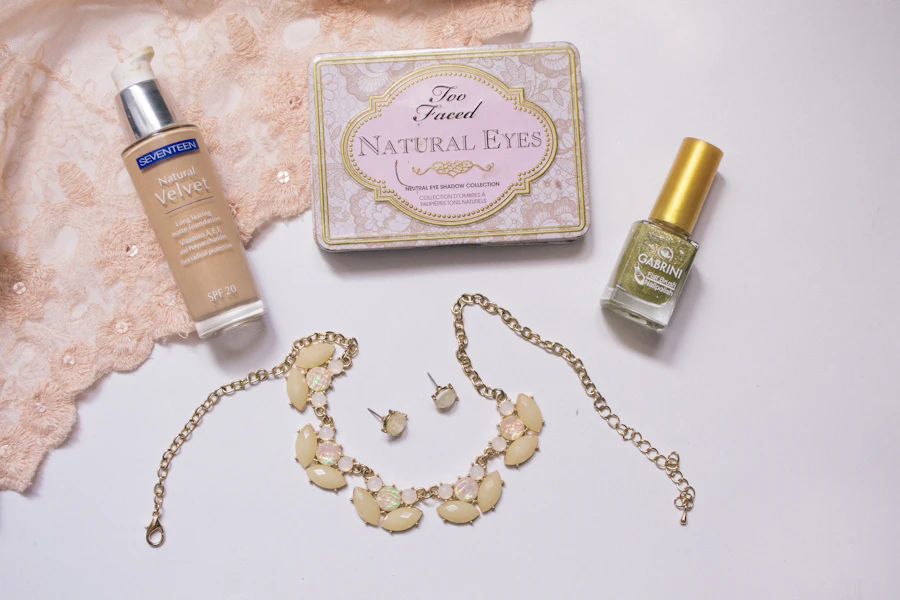 a white table topped with cosmetics and a necklace