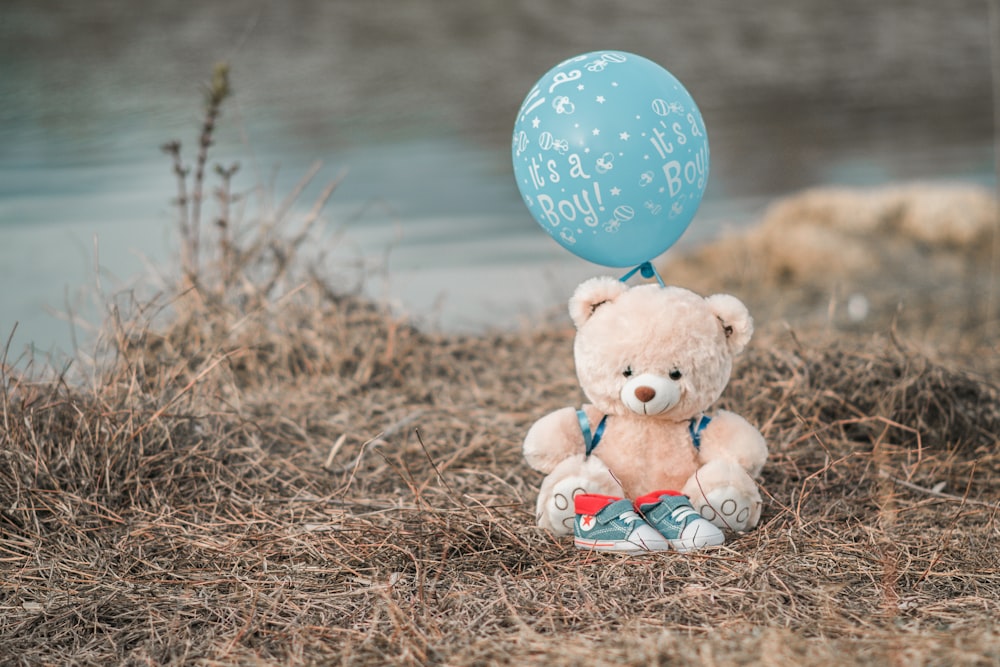 a teddy bear with a balloon attached to it