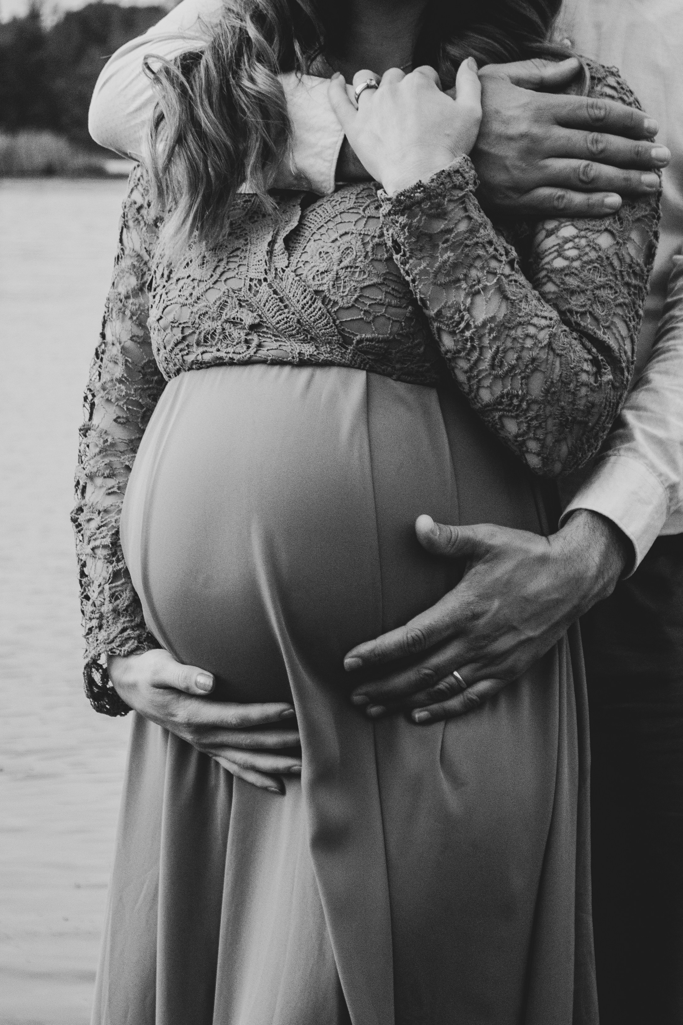 a pregnant woman is holding her husband's belly
