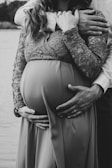 a pregnant woman is holding her husband's belly