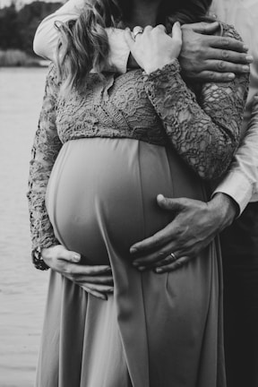 a pregnant woman is holding her husband's belly