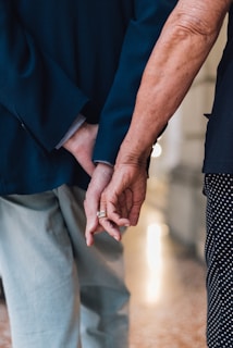 a close up of two people holding hands