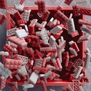 a pile of red and white legos laying on top of each other