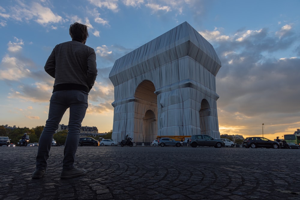 a man is standing in front of a building