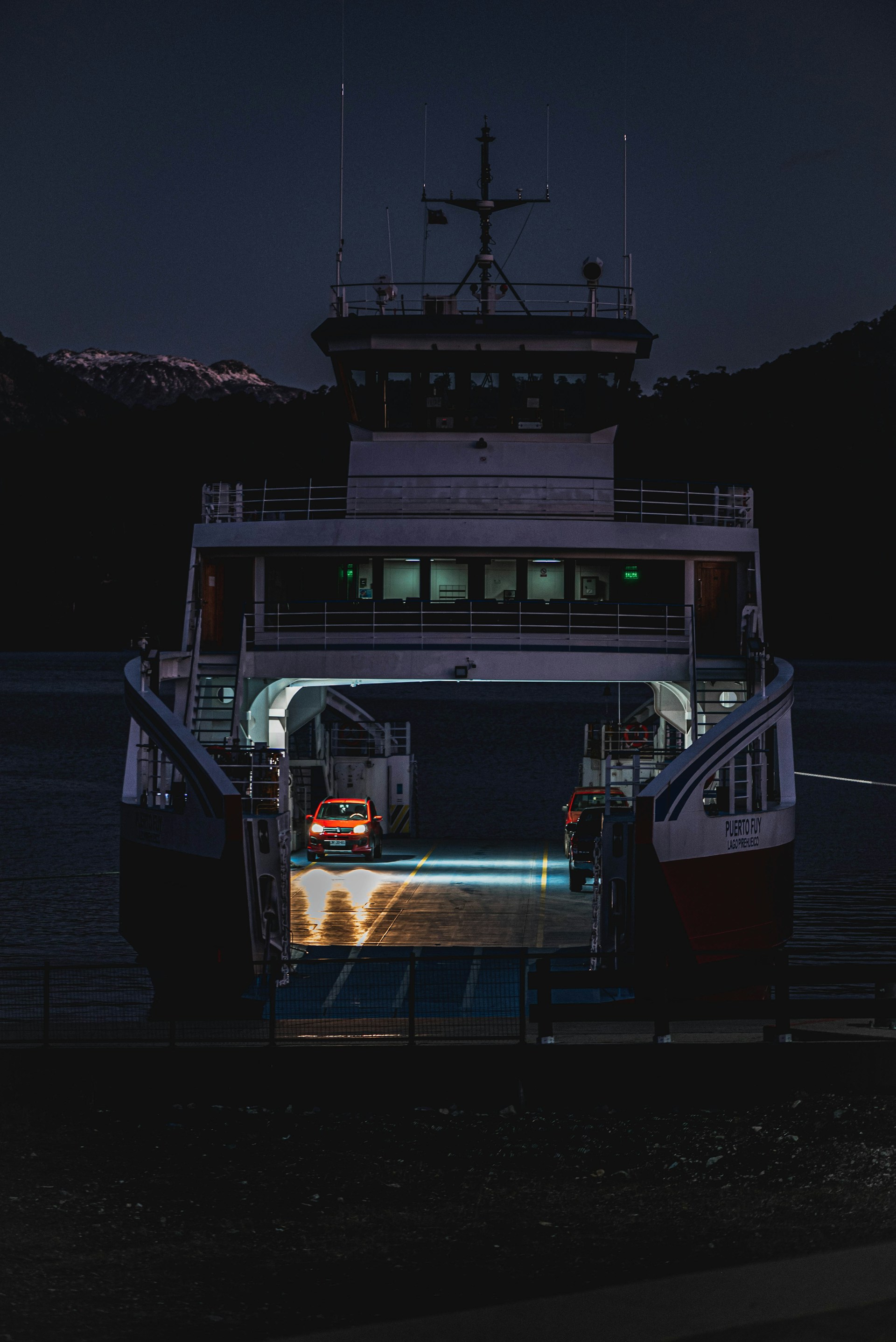 a ferry boat docked at a dock at night