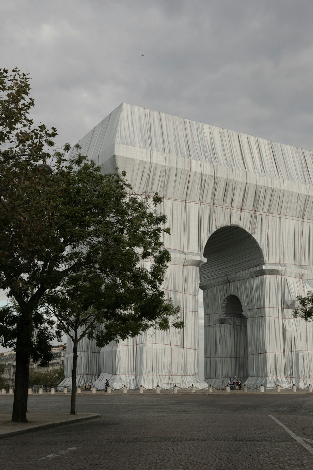 a large white building with a tree in front of it