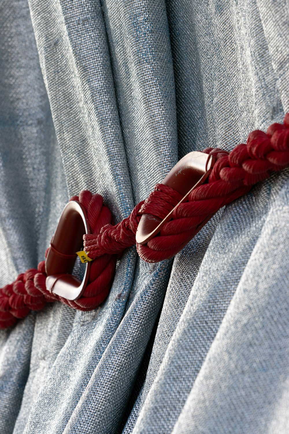 a pair of shoes that are tied to a curtain