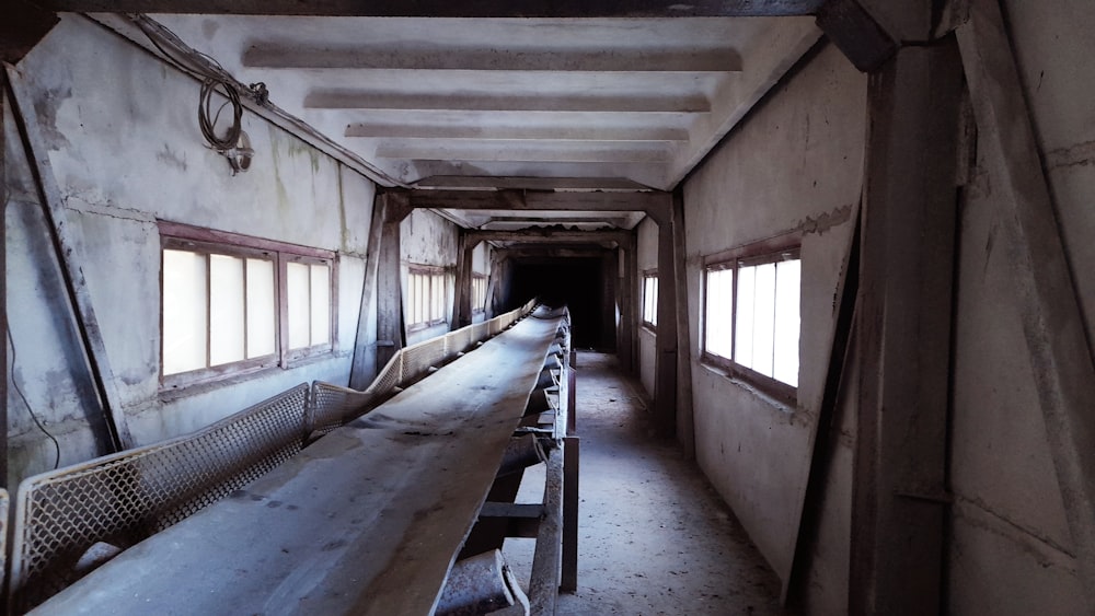 a long row of benches in a run down building