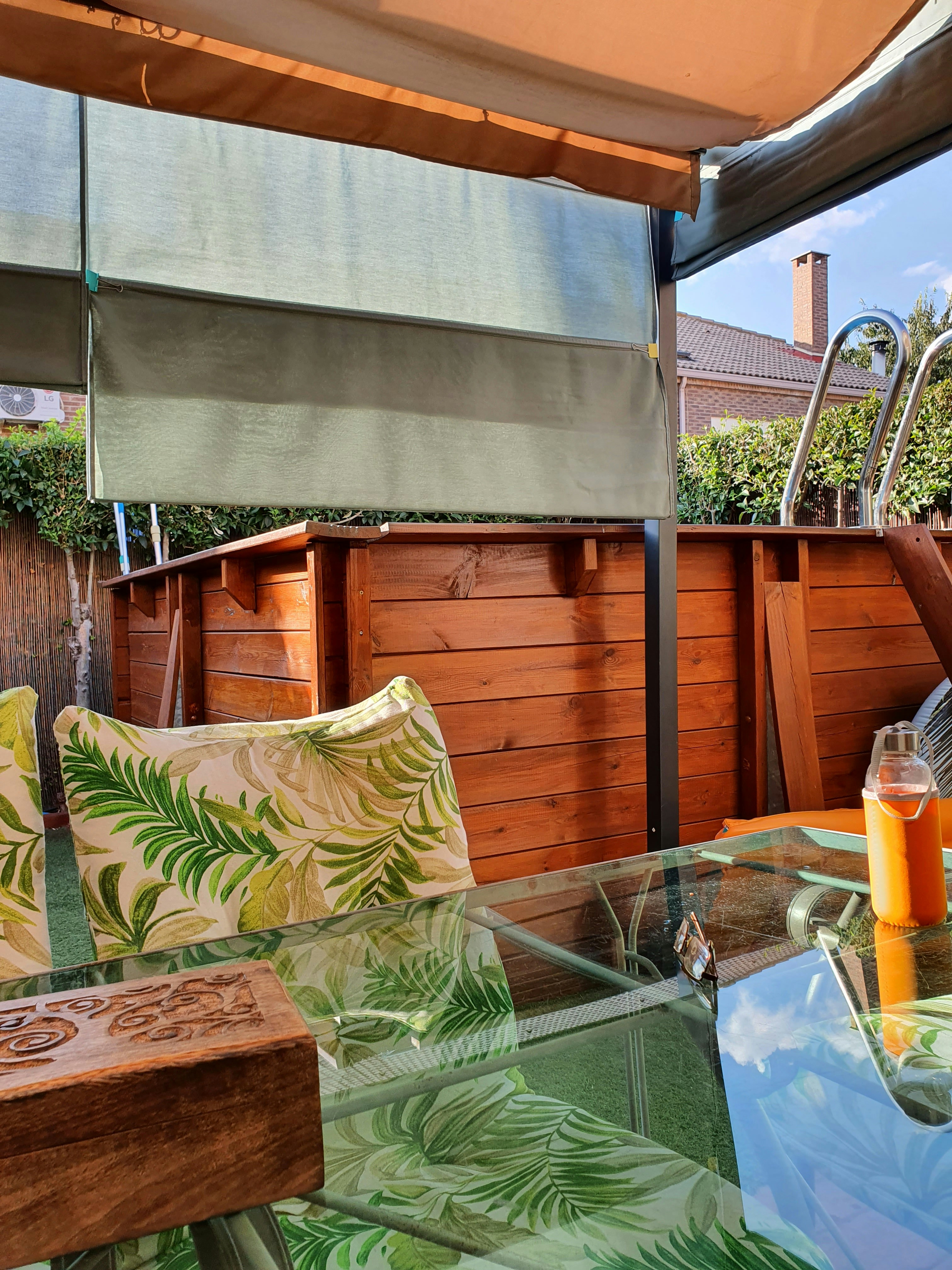 Swimming pool area with terrace seating and tropical landscaping