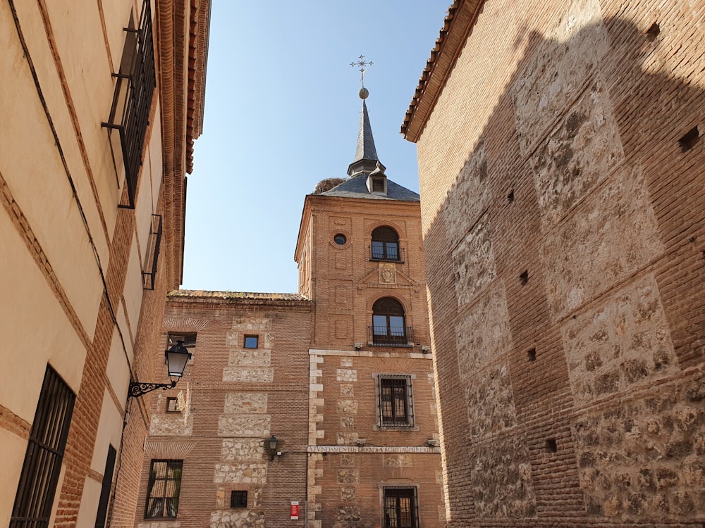 a tall brick building with a steeple on top