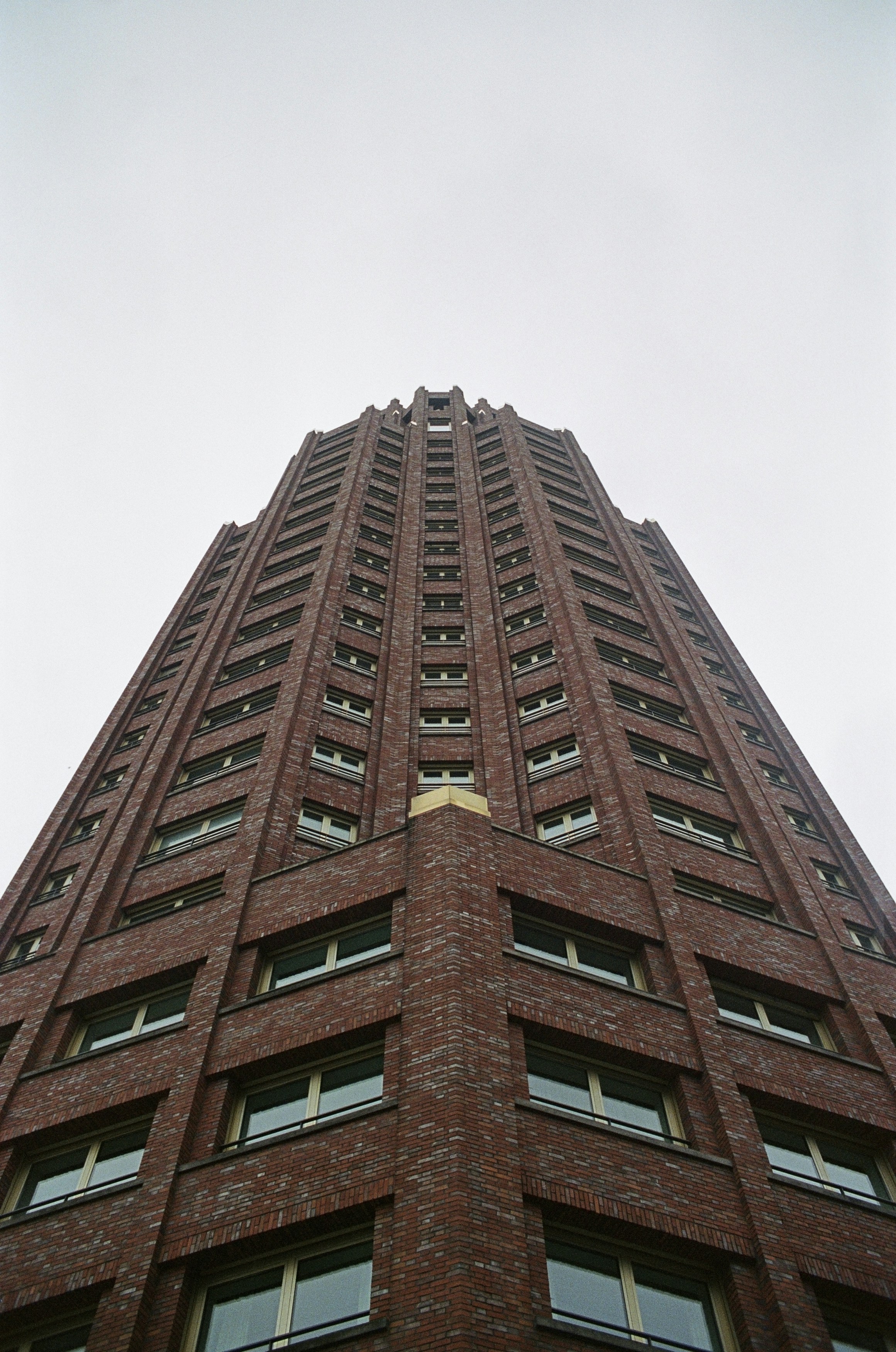 A very tall brick building with a clock on it's side photo – Free Film ...