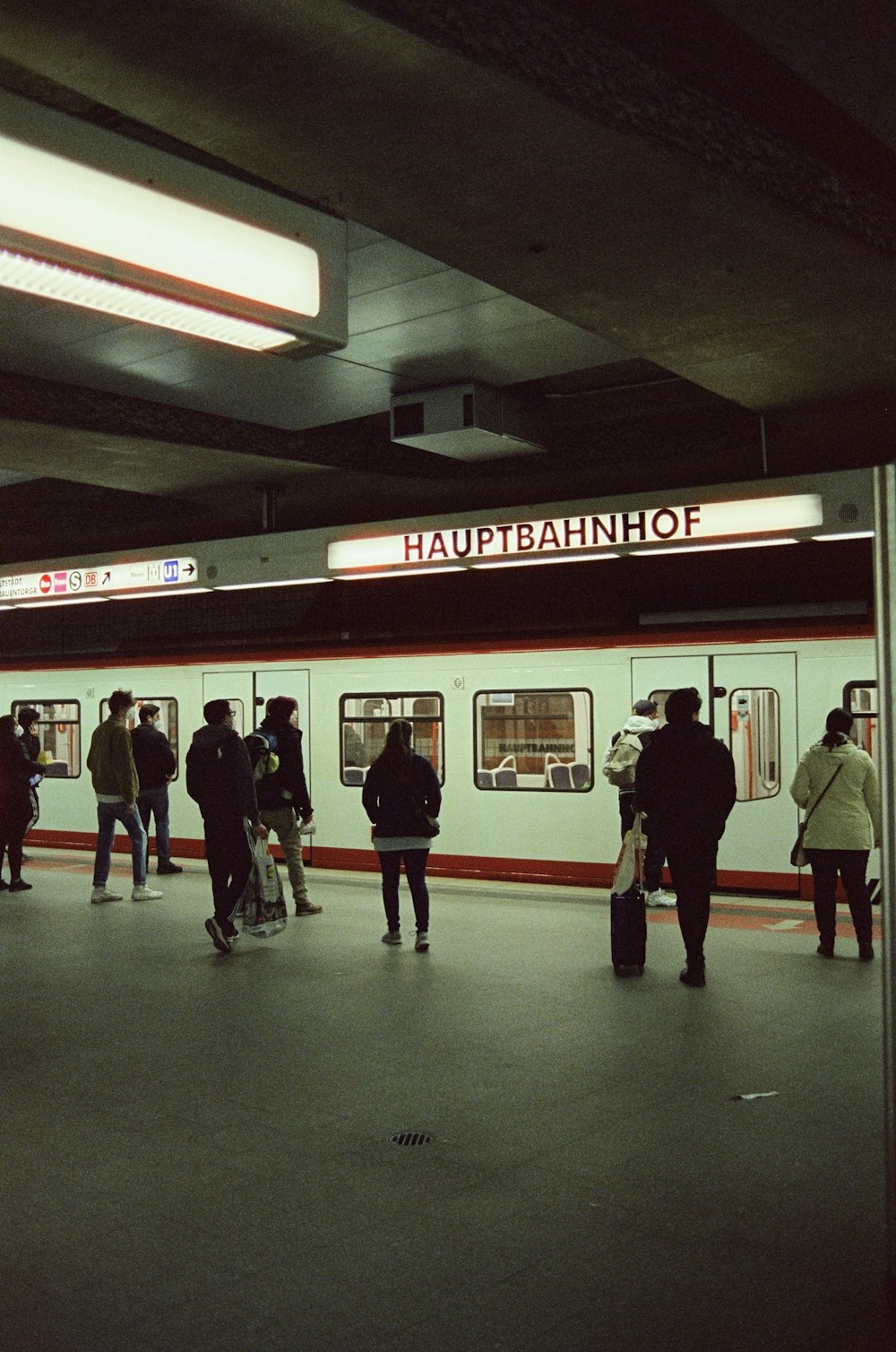 a group of people standing on a subway platform