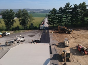 a construction site with trucks and construction equipment