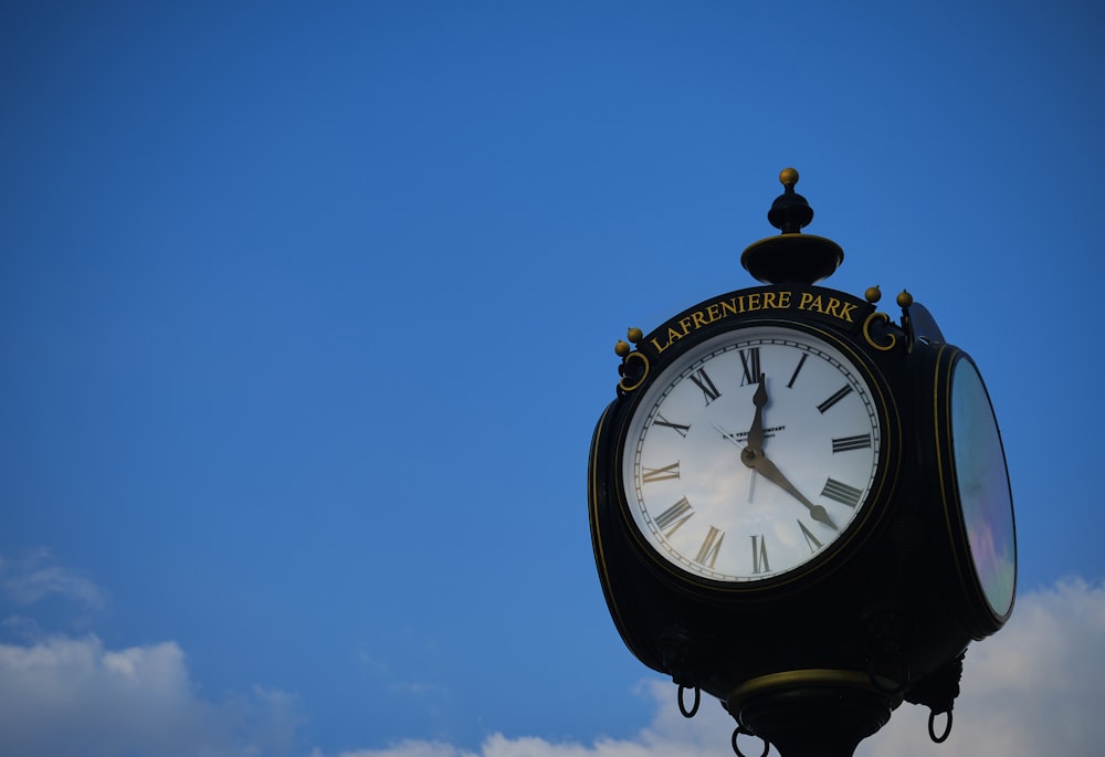 a clock with roman numerals on a clear day