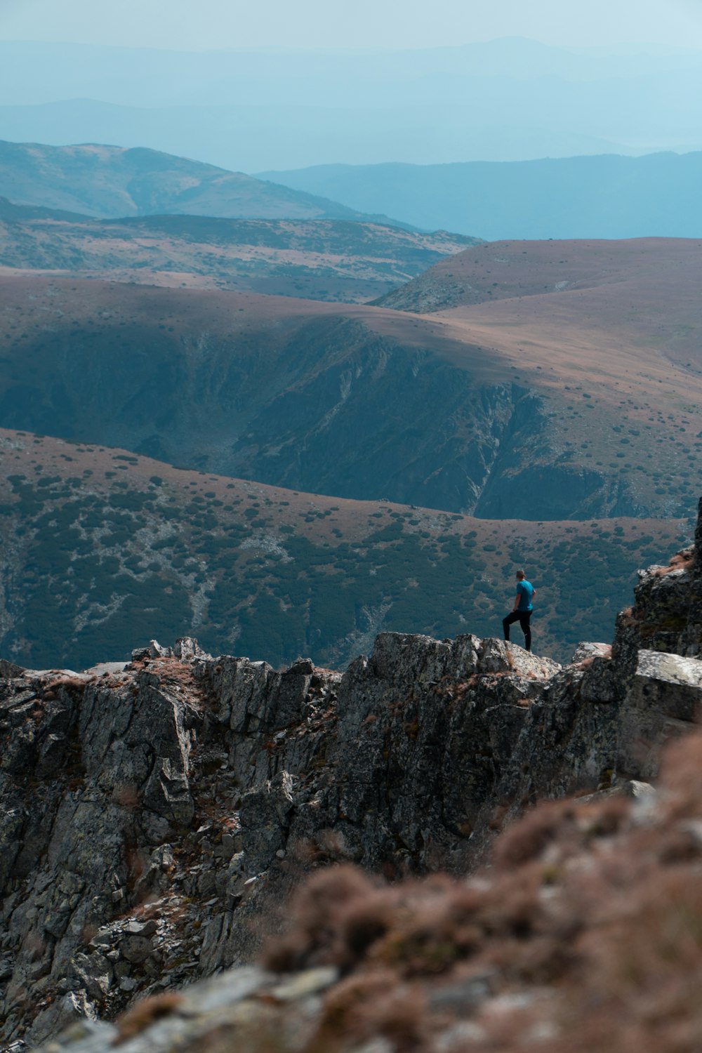a person standing on top of a rocky cliff