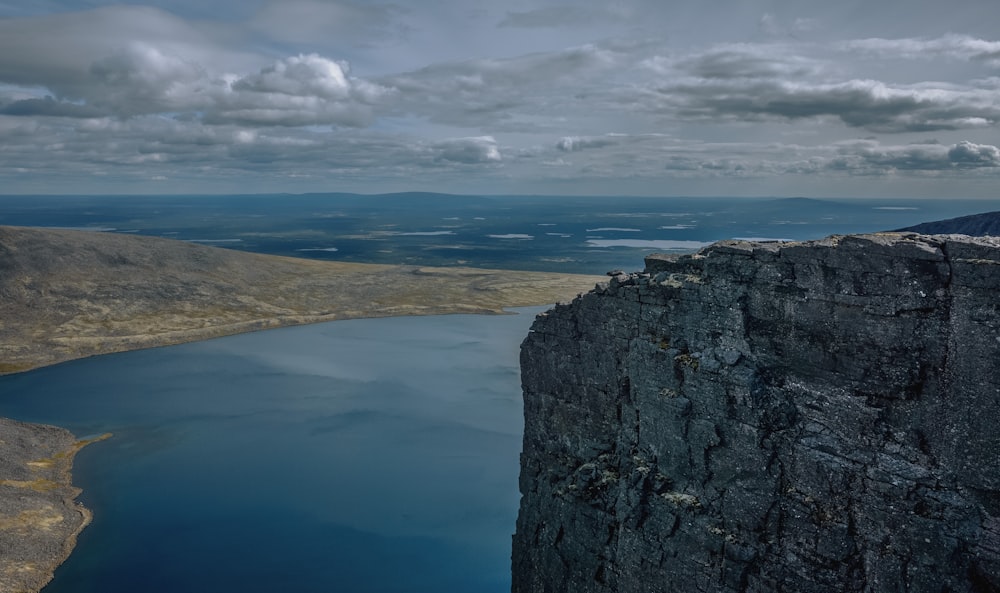 a large body of water sitting on the side of a mountain