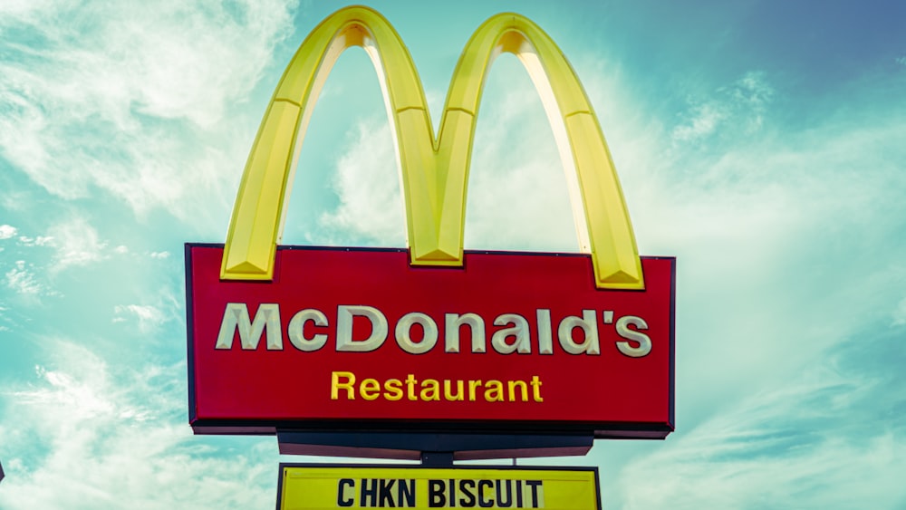 a mcdonald's restaurant sign with a sky background