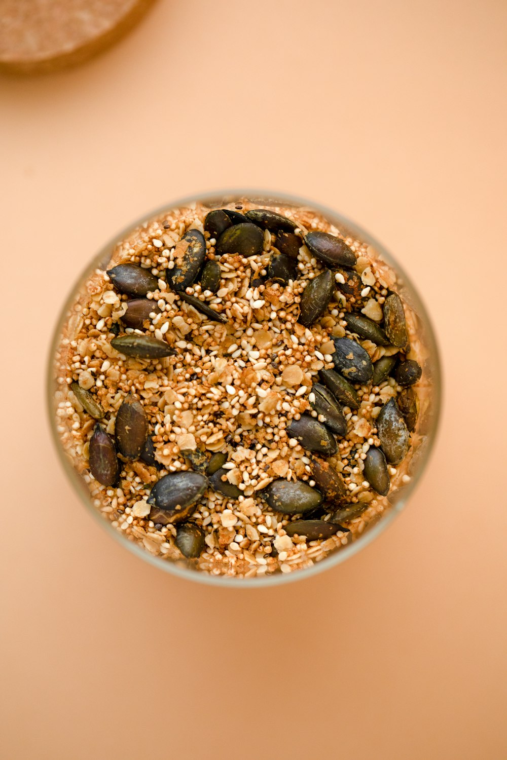 a glass bowl filled with seeds and seeds on top of a table