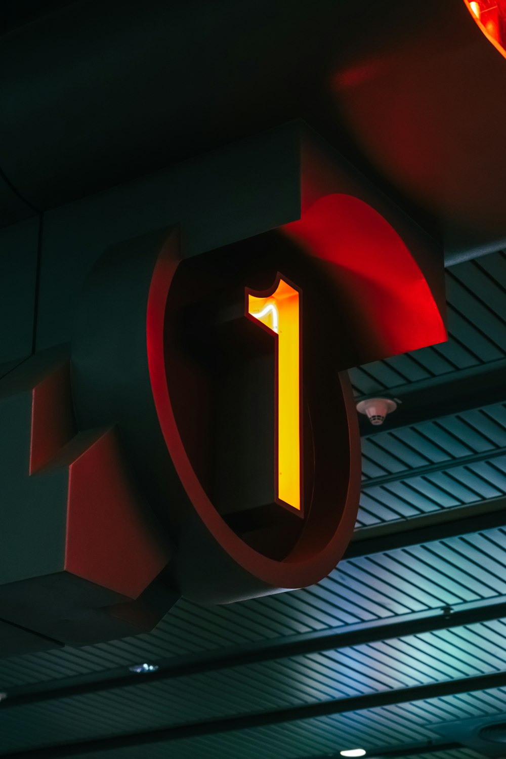 a neon sign hanging from the ceiling of a building