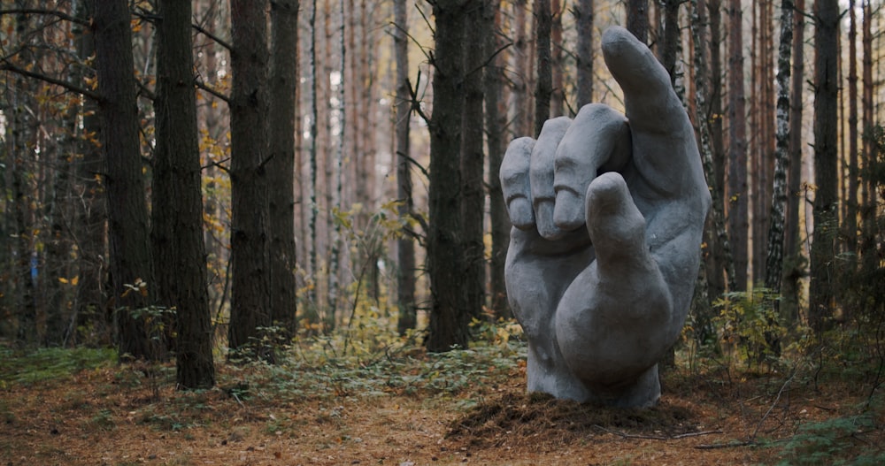 a statue in the middle of a forest