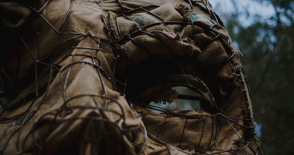 a close up of a mask with barbed wire around it