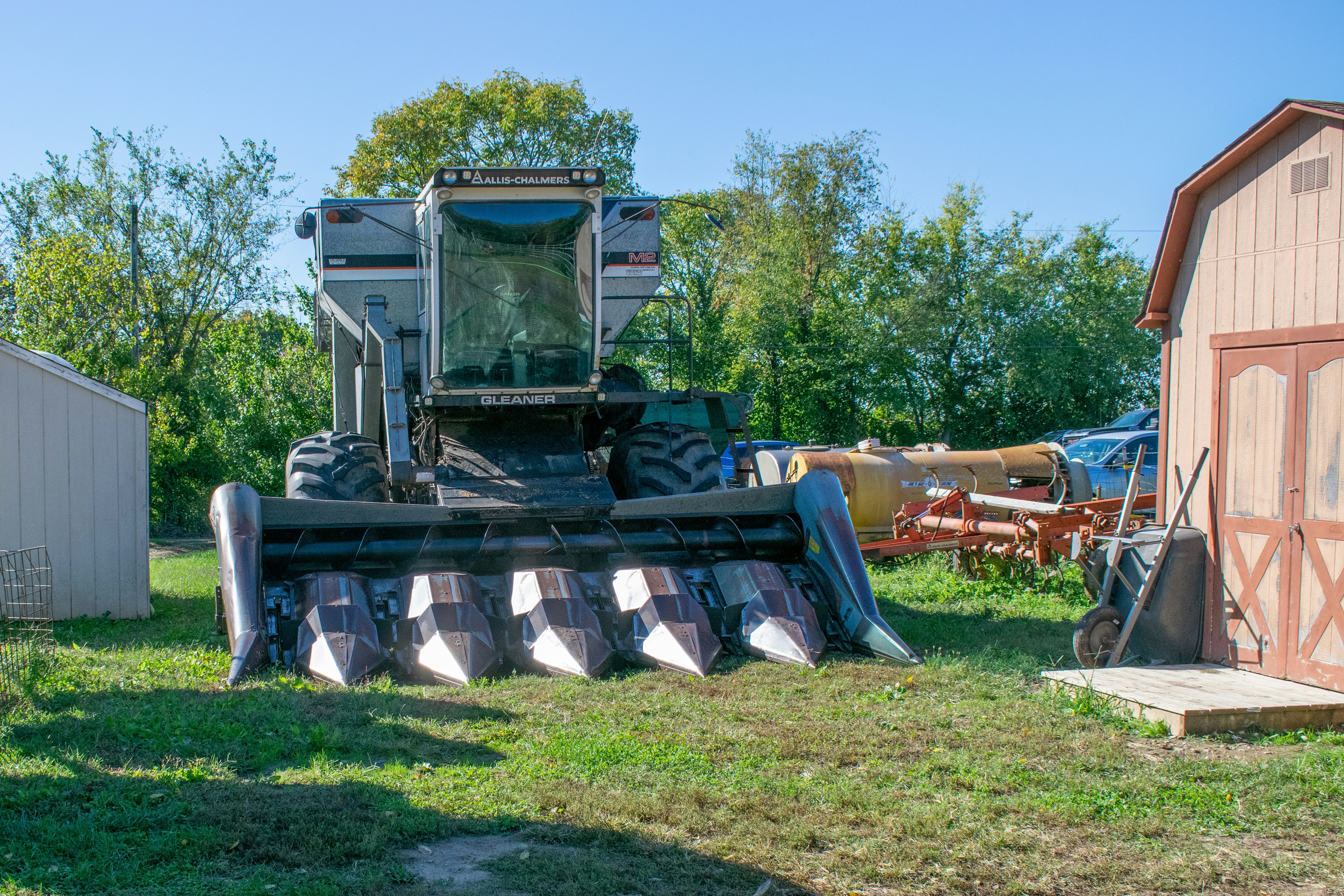 a tractor is parked next to a barn