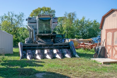 a tractor is parked next to a barn