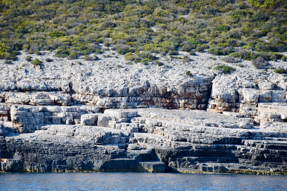 Eine große Gruppe von Felsen, die auf einem Fluss sitzen