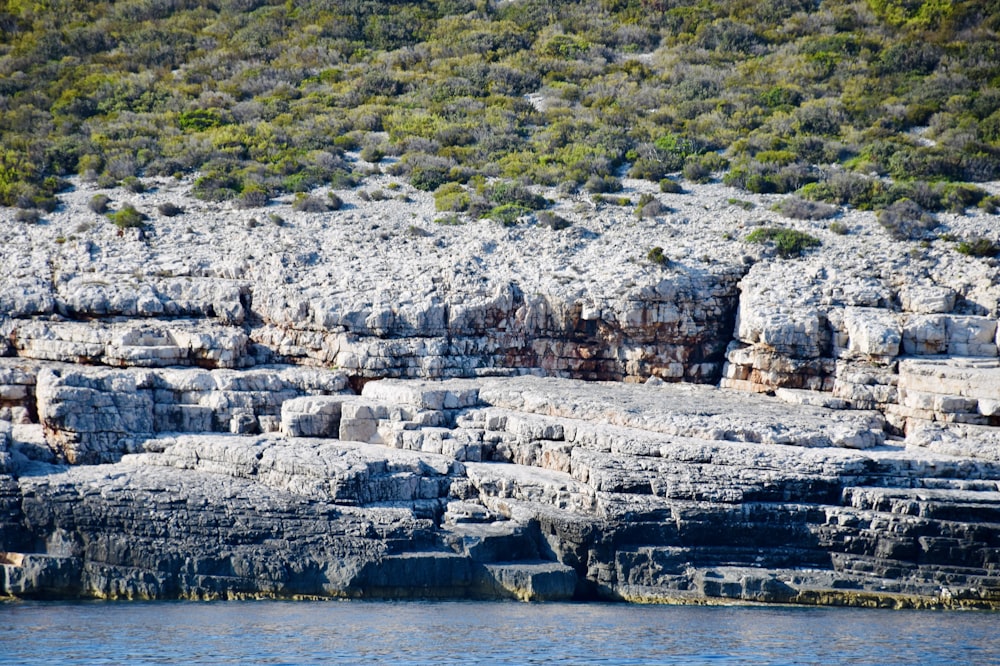 a large group of rocks sitting on top of a river