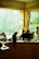 A bright kitchen countertop with a green-labeled cleaning spray and a curious cat nearby.
