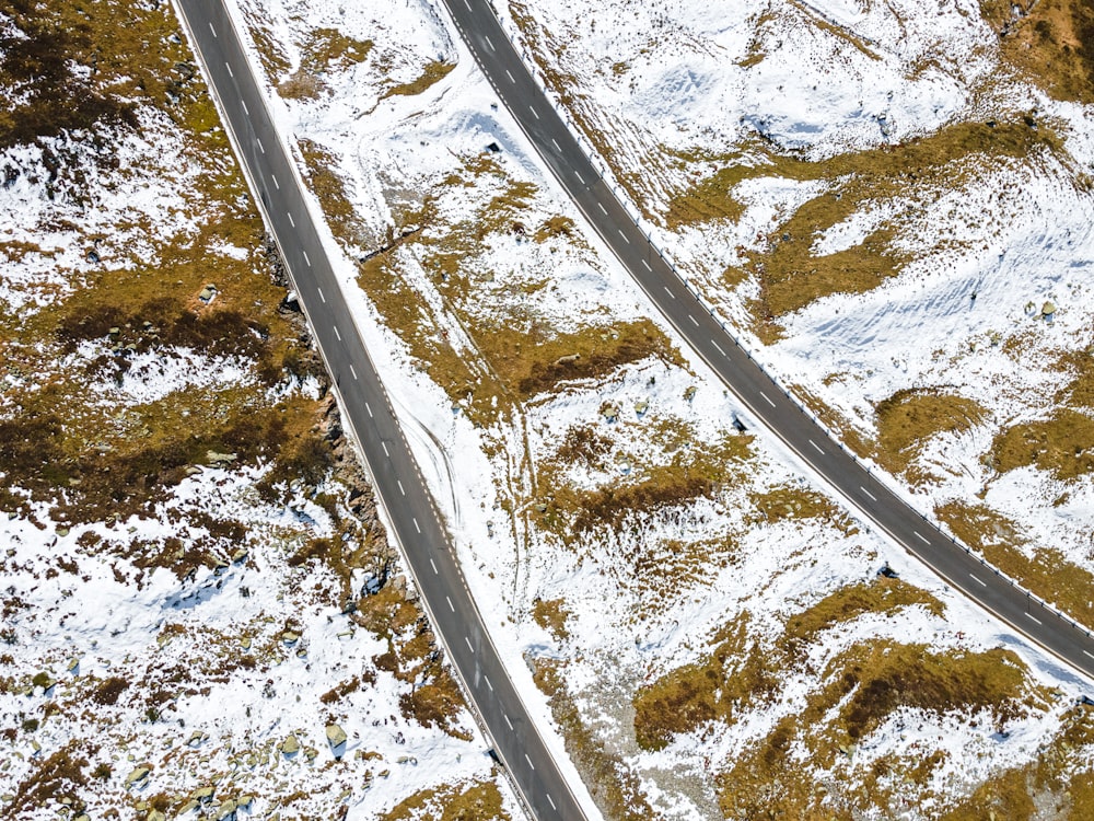 an aerial view of two roads in the snow