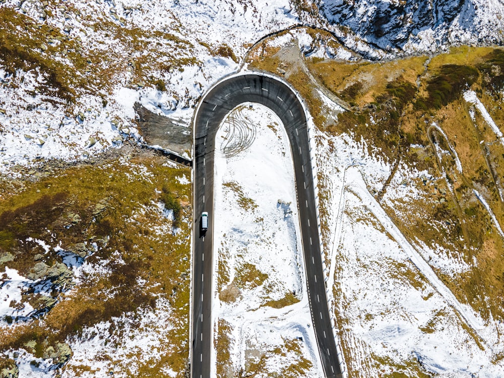 an aerial view of a winding road in the mountains