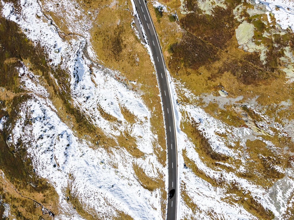 an aerial view of a winding road in the mountains