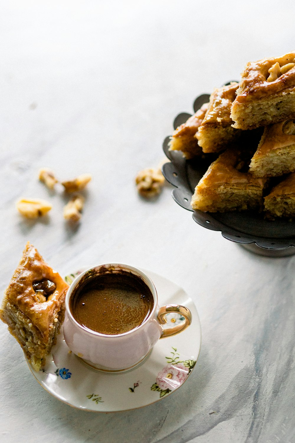 a cup of coffee next to a plate of food