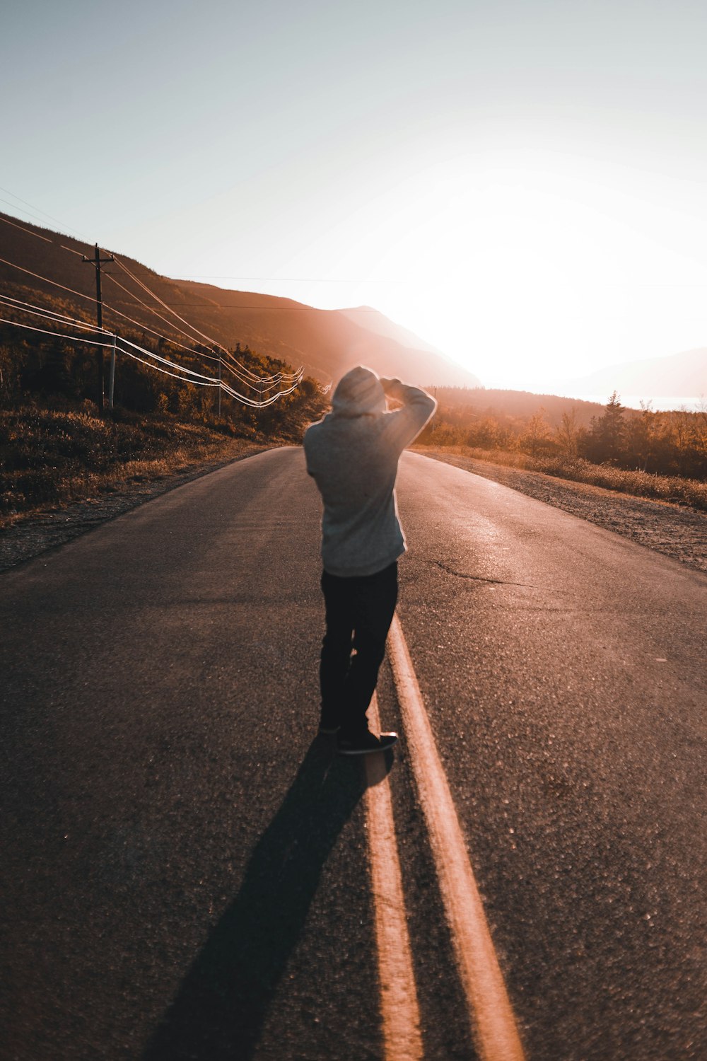 a person standing in the middle of a road