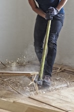 a man holding a large hammer in a room