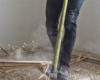 a man holding a large hammer in a room