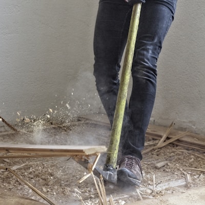 a man holding a large hammer in a room