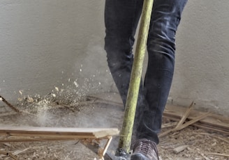 a man holding a large hammer in a room