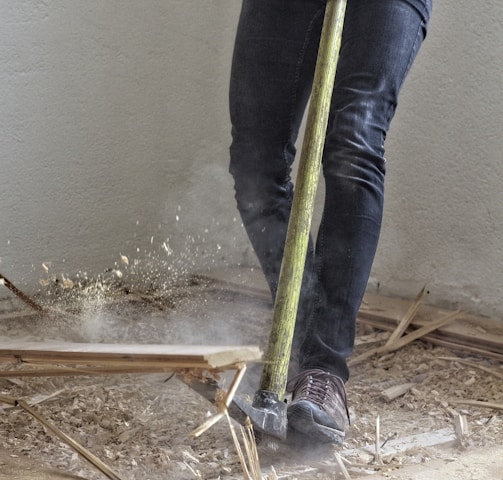 a man holding a large hammer in a room