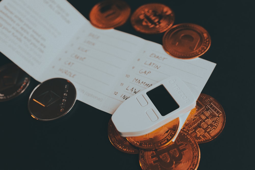 a cell phone sitting on top of a pile of coins