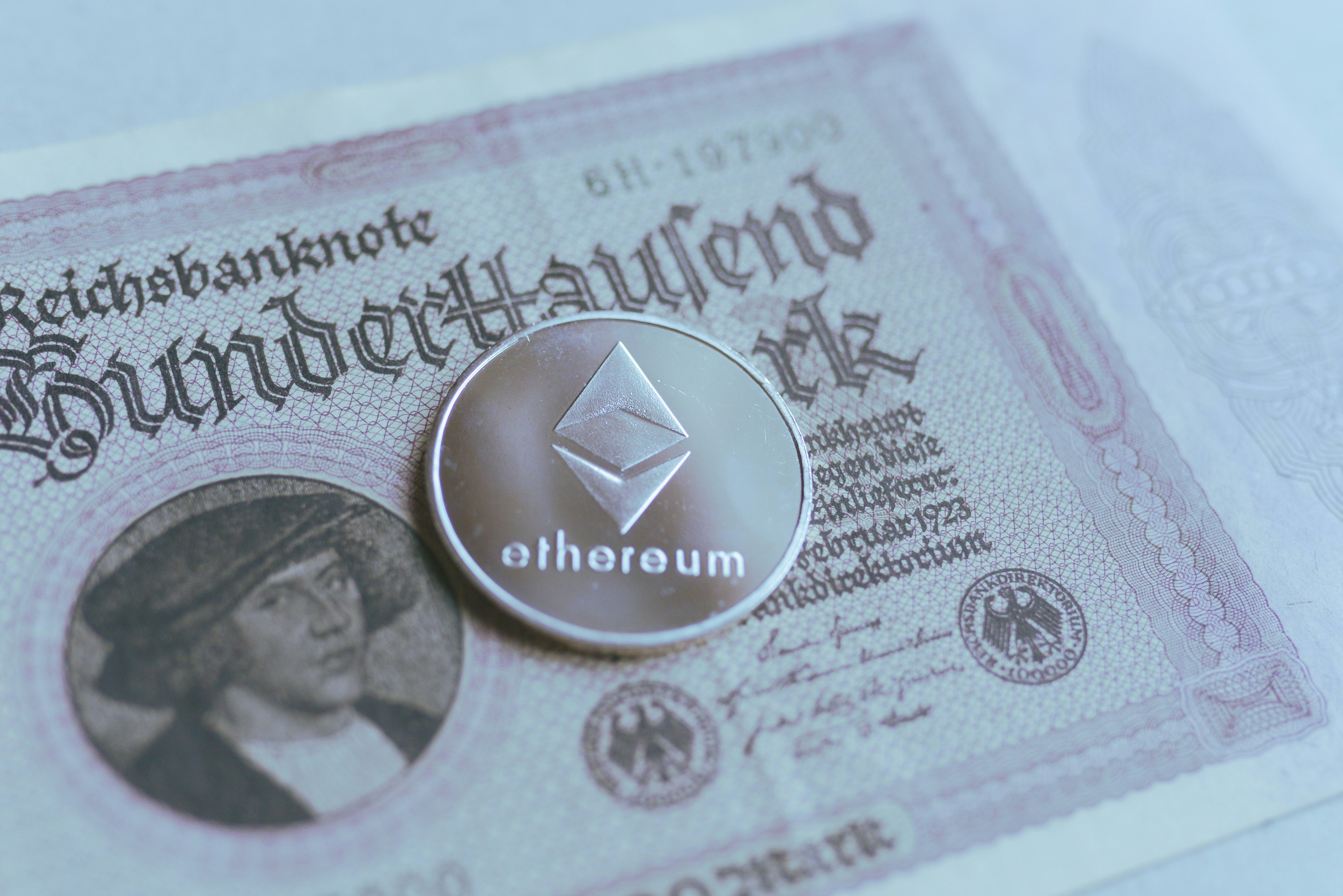 a coin sitting on top of a bank note