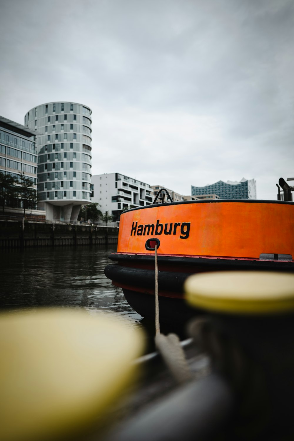 a large orange boat floating on top of a body of water