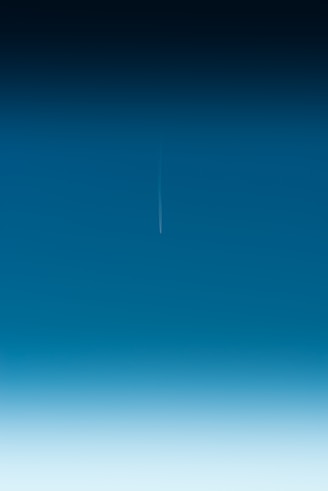 an airplane is flying in the blue sky
