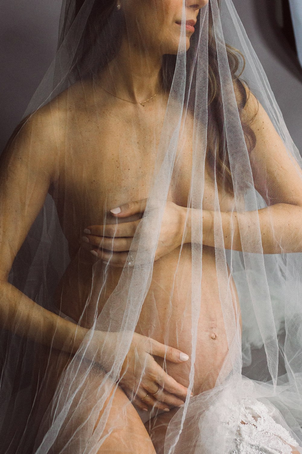 a naked woman wearing a veil and a veil over her head