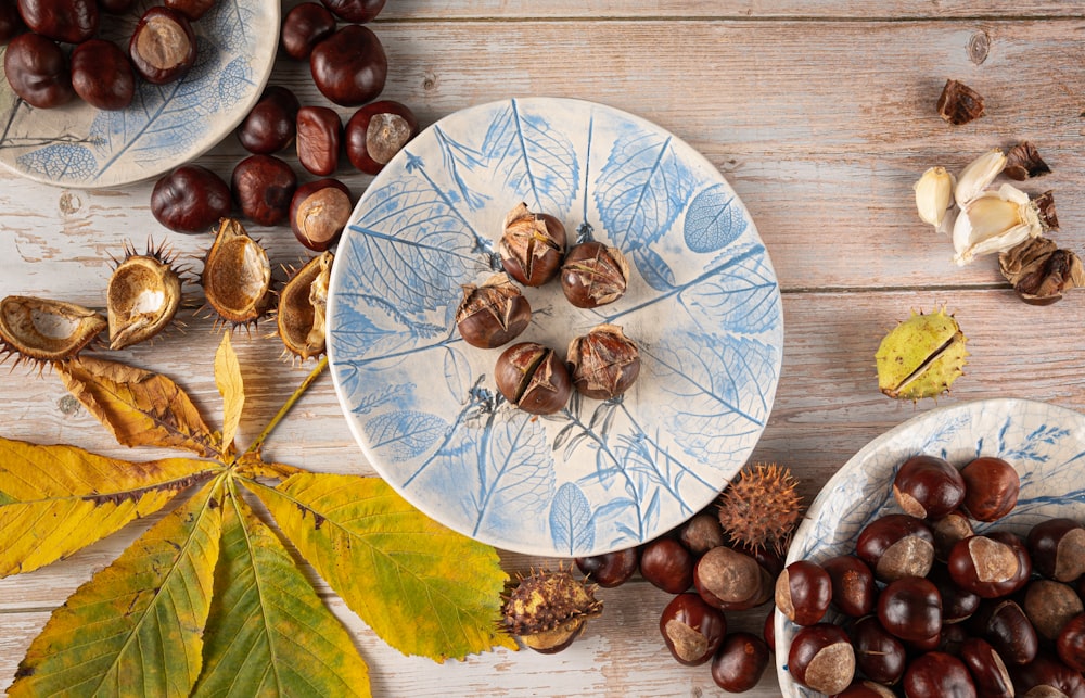 a table topped with plates and bowls filled with nuts