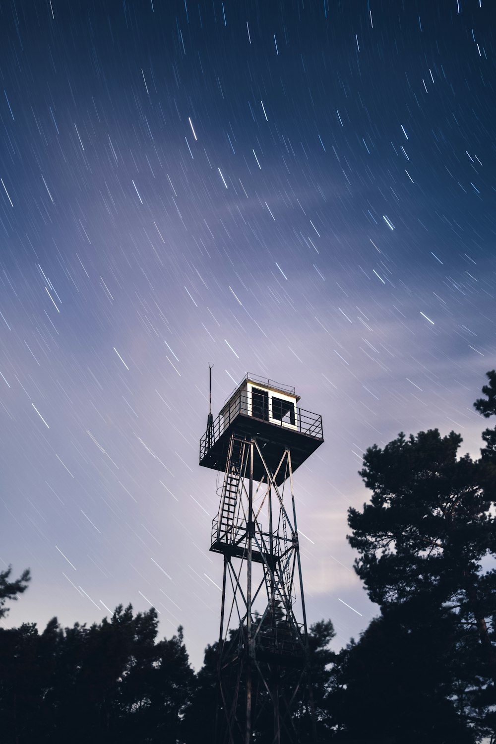 a tower that is sitting in the middle of a forest