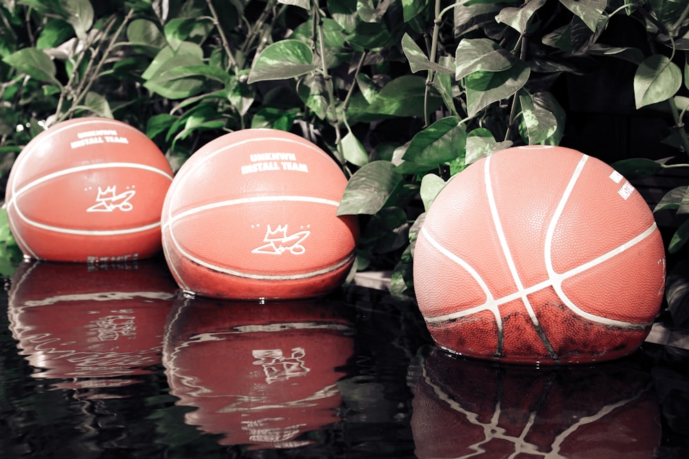 three orange balls sitting on top of a table